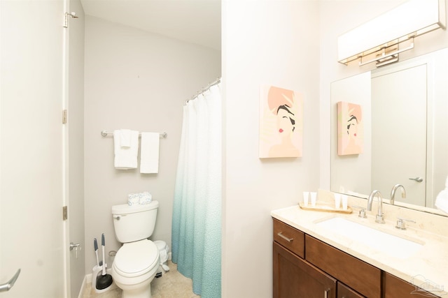 bathroom featuring toilet and vanity