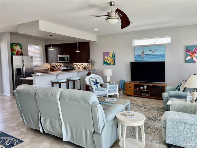 living area with a ceiling fan, recessed lighting, and light tile patterned flooring