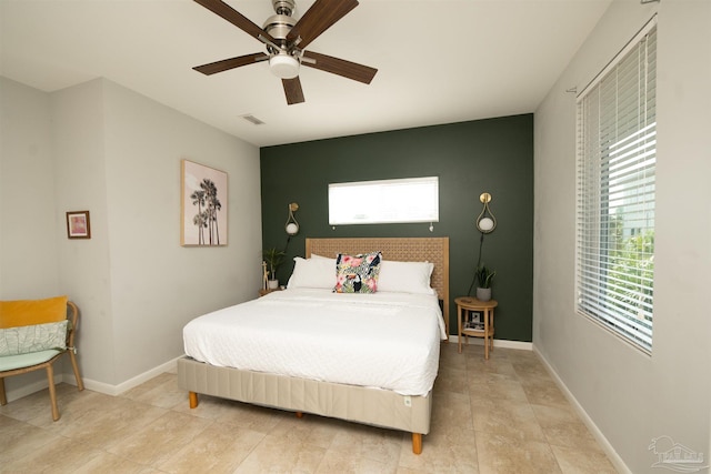 bedroom featuring visible vents, ceiling fan, and baseboards