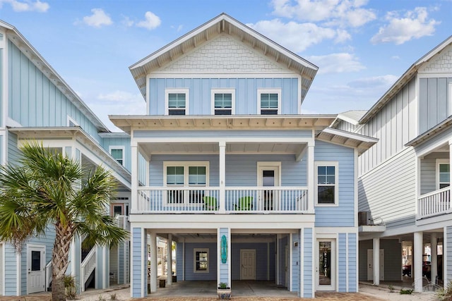 coastal inspired home with a balcony and a carport