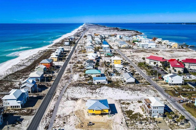 birds eye view of property with a view of the beach and a water view