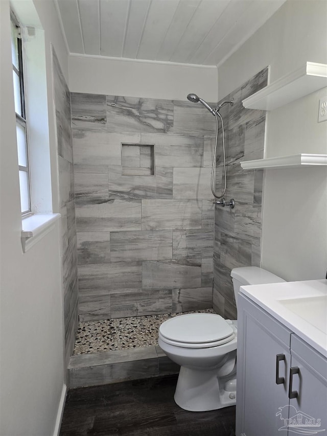 4285 W Avenida De Golf, Pace, FL 32571 - full bathroom featuring wood finished floors, toilet, tiled shower, and vanity