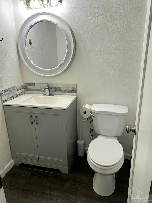 4285 W Avenida De Golf, Pace, FL 32571 - half bathroom with vanity, toilet, wood finished floors, and baseboards