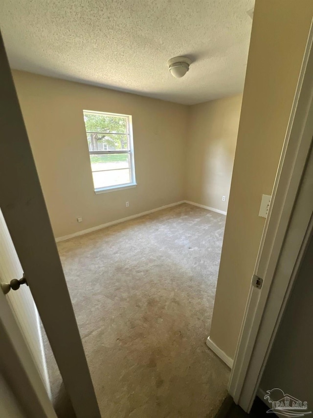 4285 W Avenida De Golf, Pace, FL 32571 - empty room featuring a textured ceiling, carpet, and baseboards