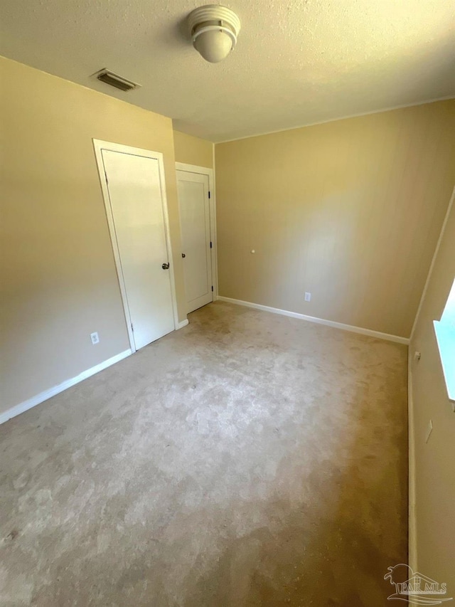 4285 W Avenida De Golf, Pace, FL 32571 - spare room with a textured ceiling, carpet flooring, and baseboards