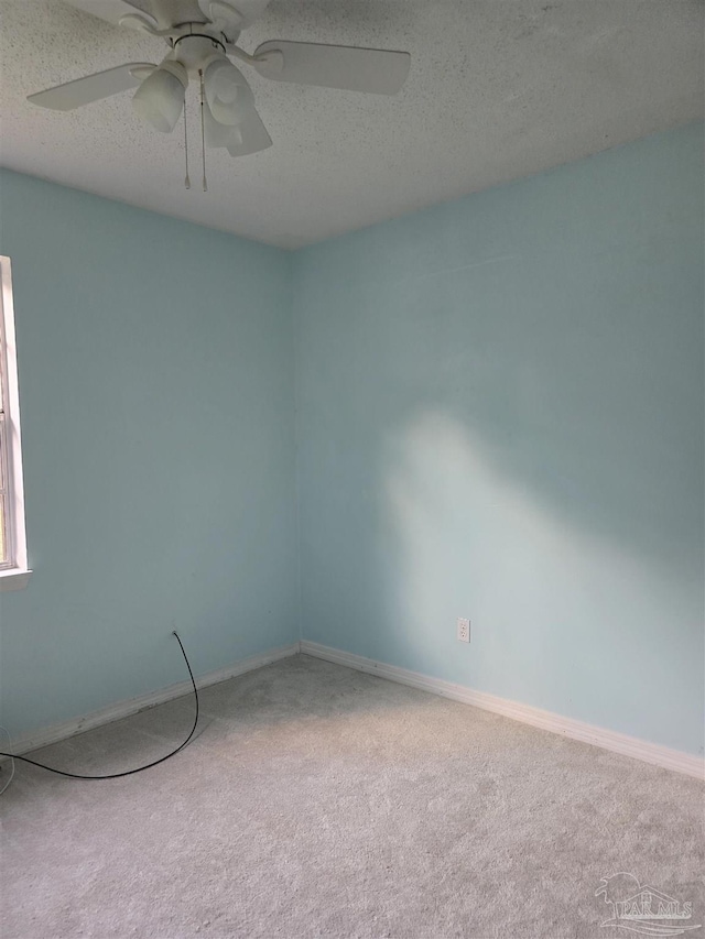 4285 W Avenida De Golf, Pace, FL 32571 - carpeted empty room featuring a textured ceiling, baseboards, and a ceiling fan