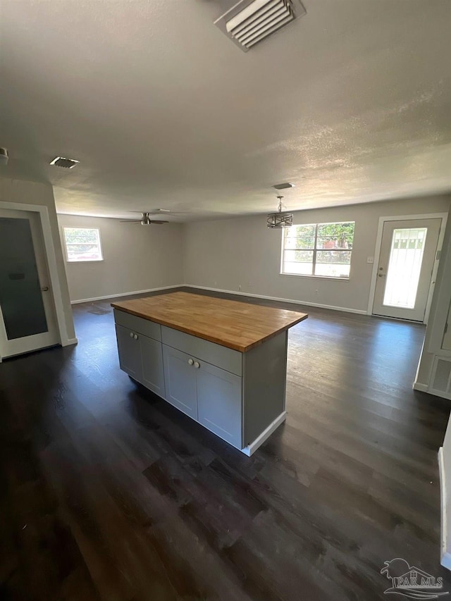 4285 W Avenida De Golf, Pace, FL 32571 - kitchen with butcher block counters, dark wood-style flooring, open floor plan, baseboards, and a kitchen island
