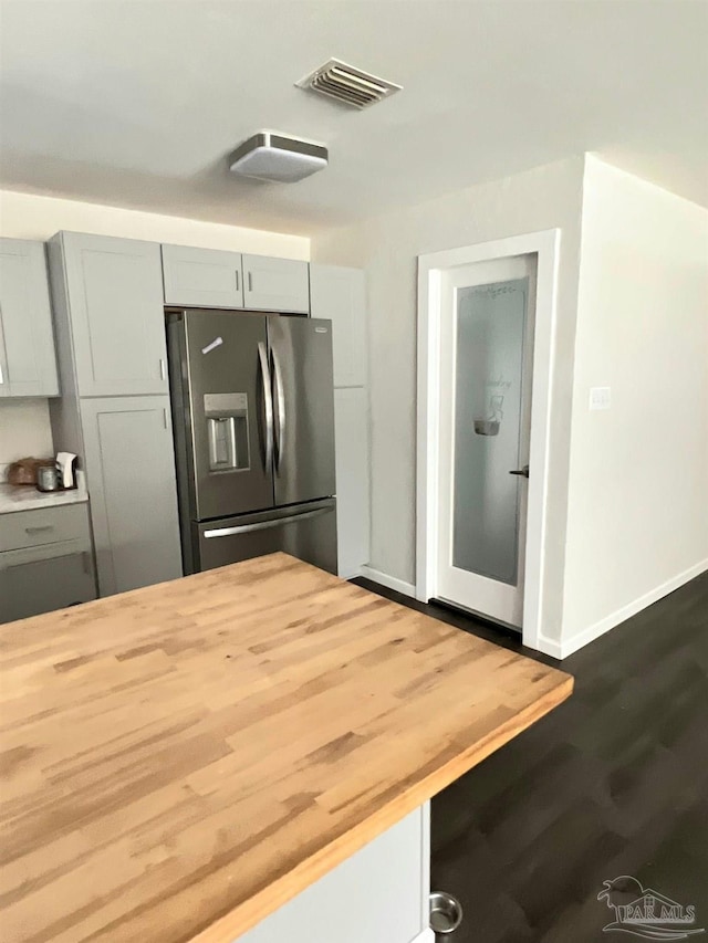 4285 W Avenida De Golf, Pace, FL 32571 - kitchen with stainless steel fridge with ice dispenser, butcher block countertops, dark wood finished floors, baseboards, and gray cabinetry
