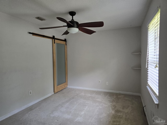 4285 W Avenida De Golf, Pace, FL 32571 - unfurnished room with a ceiling fan, carpet, a barn door, and baseboards