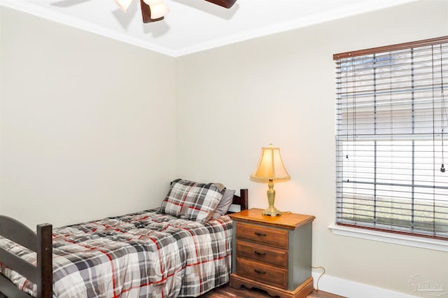 bedroom with hardwood / wood-style floors, ceiling fan, and ornamental molding