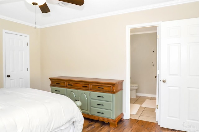 bedroom with ceiling fan, ensuite bath, light hardwood / wood-style floors, and crown molding