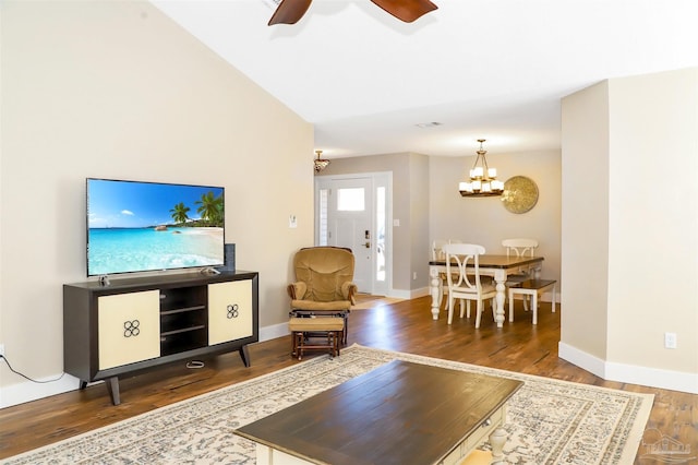 living room with ceiling fan with notable chandelier and wood-type flooring