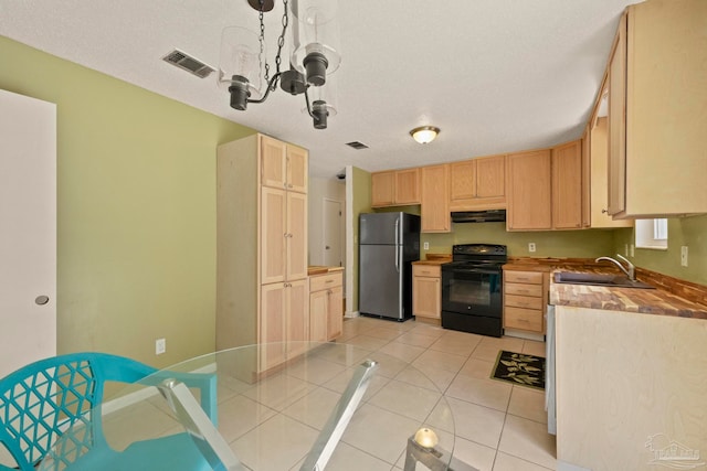 kitchen featuring light brown cabinets, sink, black electric range, stainless steel fridge, and a chandelier