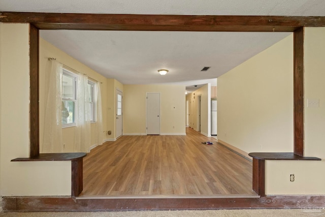 empty room featuring hardwood / wood-style floors and a textured ceiling