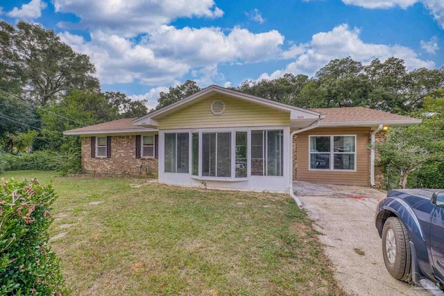 rear view of property featuring a yard