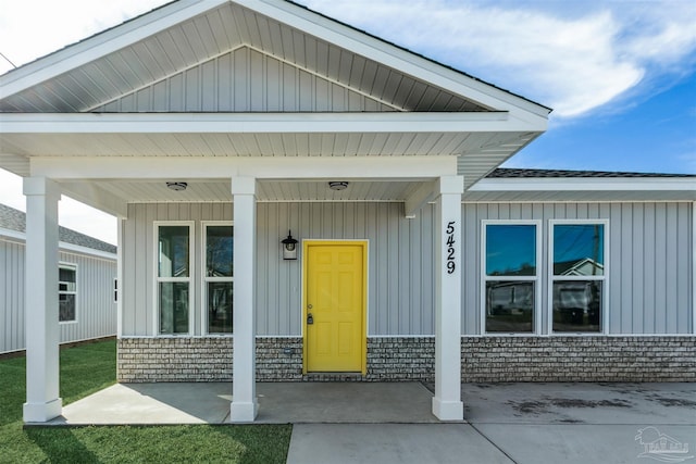 view of exterior entry with covered porch