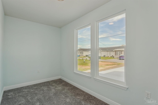 empty room with dark carpet