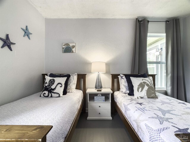 bedroom featuring dark hardwood / wood-style floors and a textured ceiling