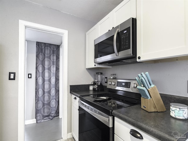 kitchen featuring appliances with stainless steel finishes and white cabinets