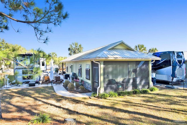 rear view of house featuring a yard