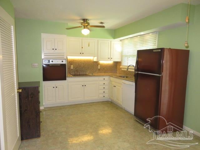 kitchen featuring white cabinets, oven, white dishwasher, ceiling fan, and refrigerator