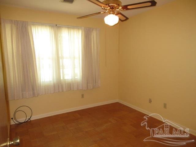 spare room featuring ceiling fan and hardwood / wood-style flooring