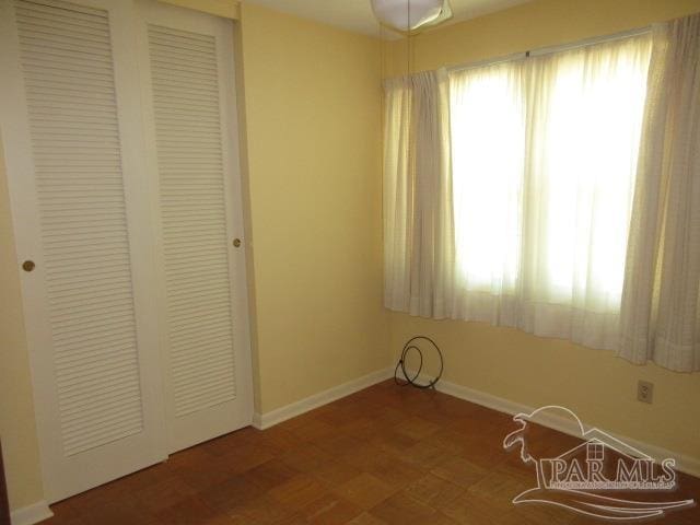 unfurnished bedroom featuring a closet and hardwood / wood-style flooring