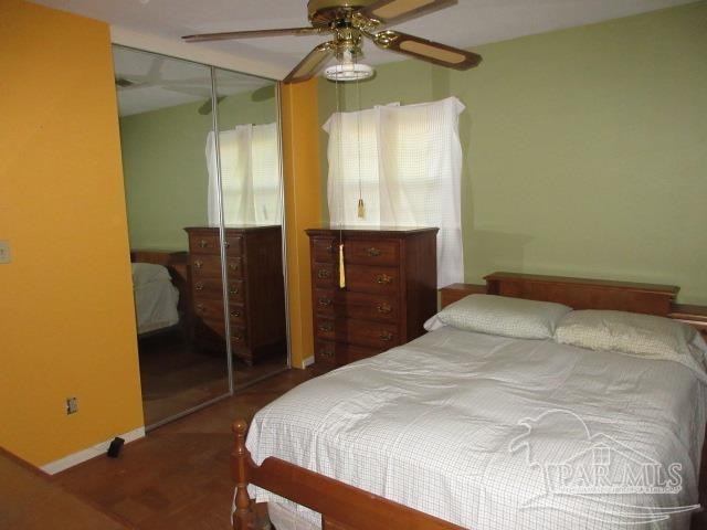 bedroom with ceiling fan and a closet