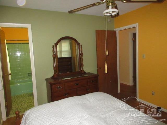 bedroom with ceiling fan and ensuite bathroom