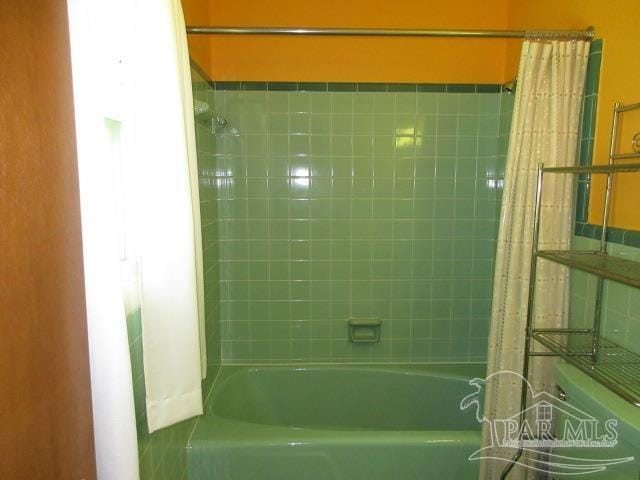 bathroom with shower / bath combination with curtain