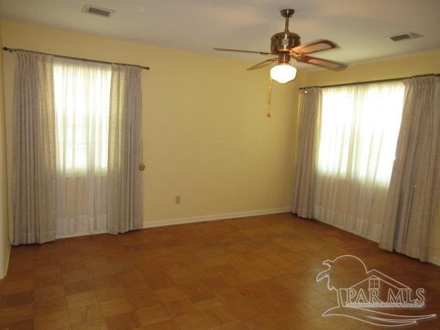 unfurnished room with ceiling fan