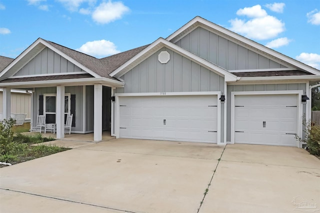 single story home featuring covered porch, an attached garage, concrete driveway, and roof with shingles