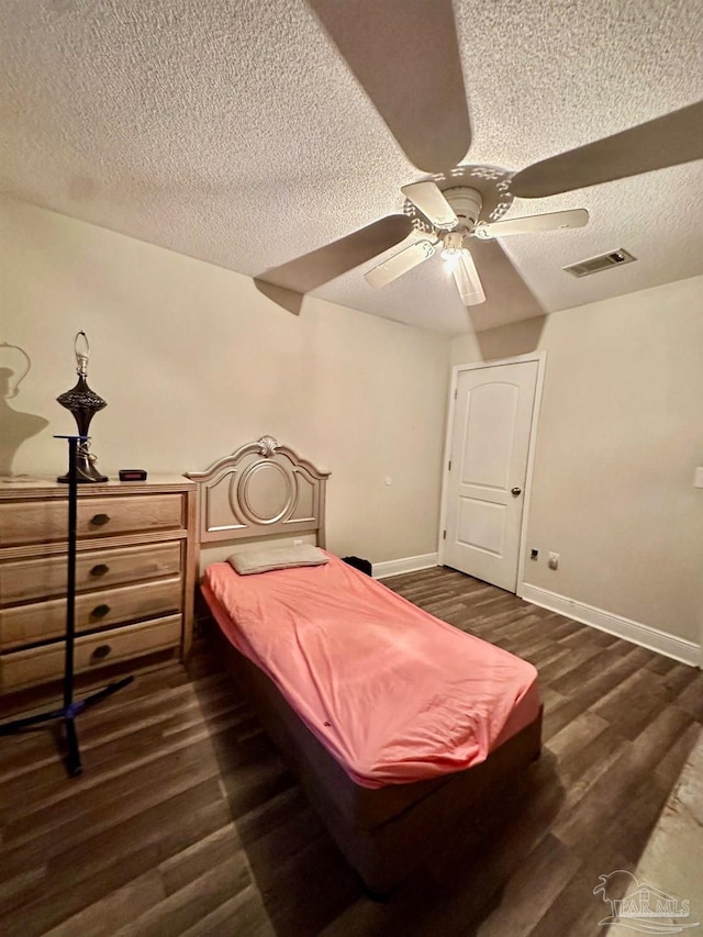 bedroom featuring a textured ceiling, pool table, dark hardwood / wood-style floors, and ceiling fan