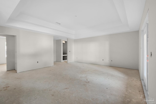 spare room with a tray ceiling