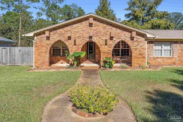 view of front of house with a patio area and a front yard