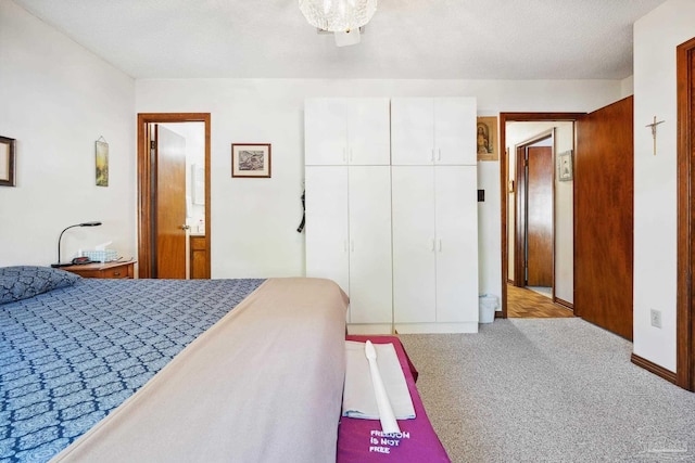 bedroom featuring a textured ceiling and light carpet