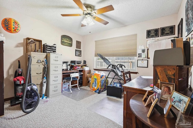 carpeted office featuring a textured ceiling and ceiling fan