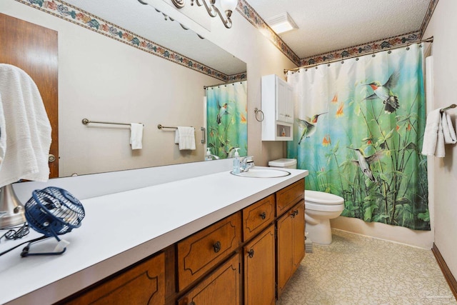 bathroom featuring vanity, toilet, and a textured ceiling