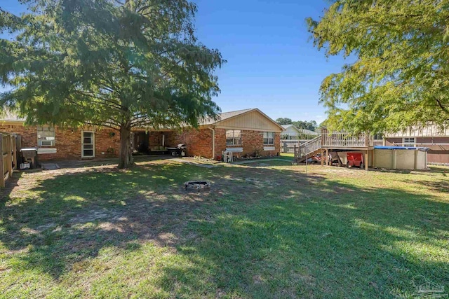 view of yard with a pool side deck