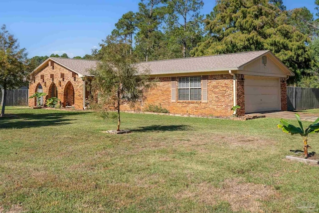 ranch-style house featuring a garage and a front yard