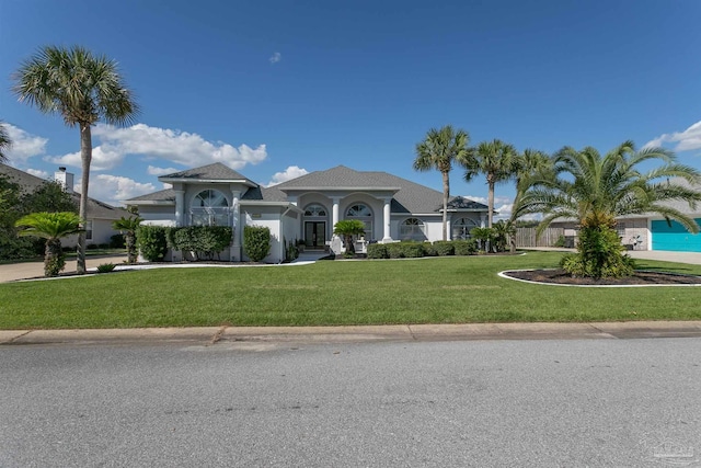 mediterranean / spanish-style house with a front yard