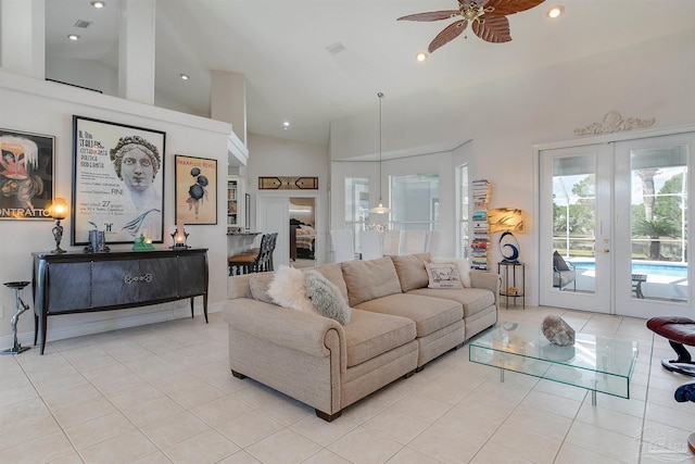 tiled living room featuring french doors, ceiling fan, and high vaulted ceiling