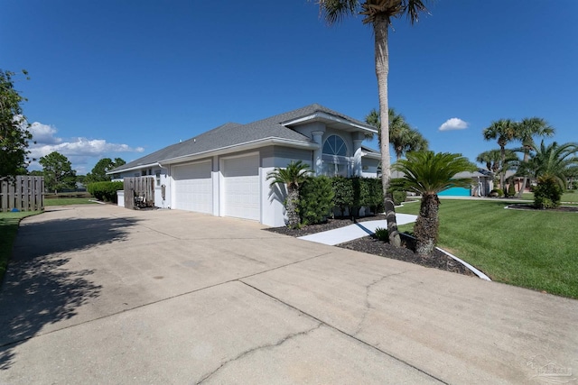 view of front of house with a garage and a front yard