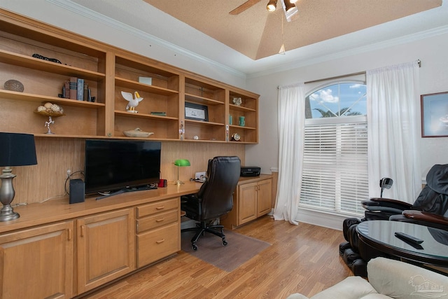 office featuring light hardwood / wood-style floors, a textured ceiling, ornamental molding, ceiling fan, and built in desk