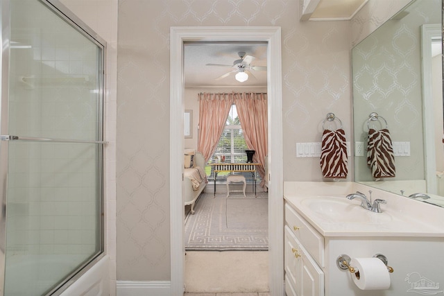 bathroom with enclosed tub / shower combo, ceiling fan, and vanity