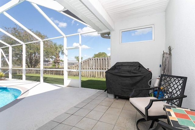 view of patio with a lanai, a fenced in pool, and a grill