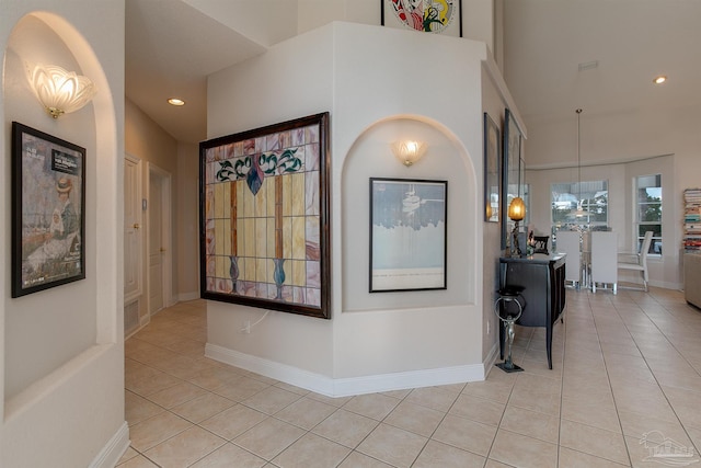 hall with light tile patterned floors