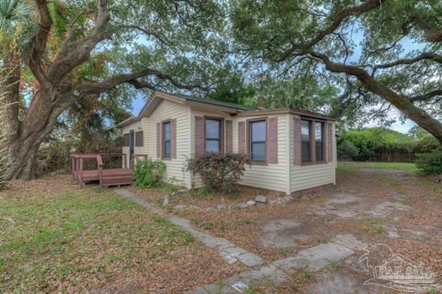 view of side of property featuring a wooden deck