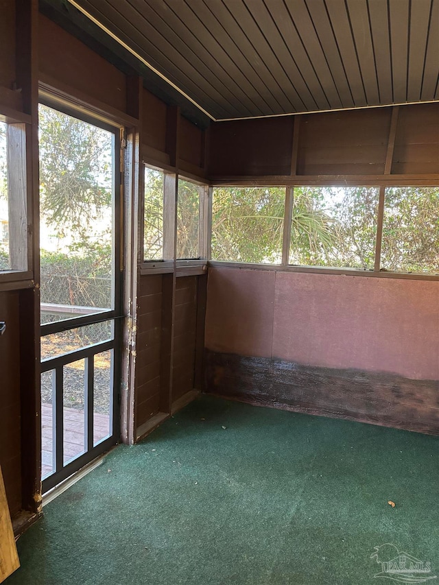 unfurnished sunroom featuring wooden ceiling