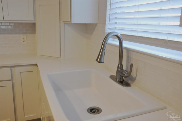 details with light countertops, a sink, and decorative backsplash